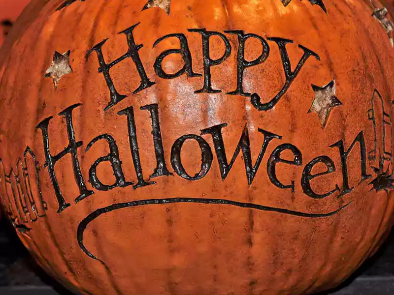 happy halloween text on pumpkin