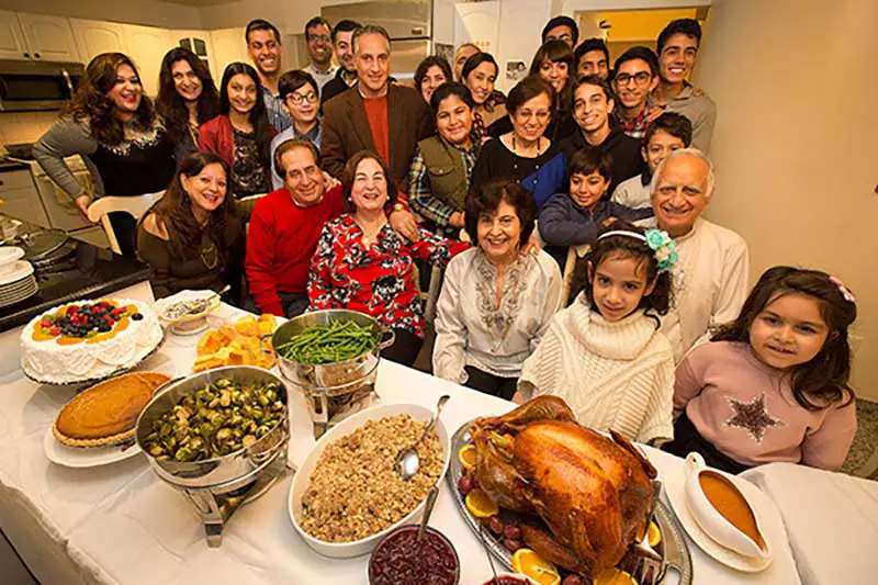 family members celebrating thanksgiving dinner party